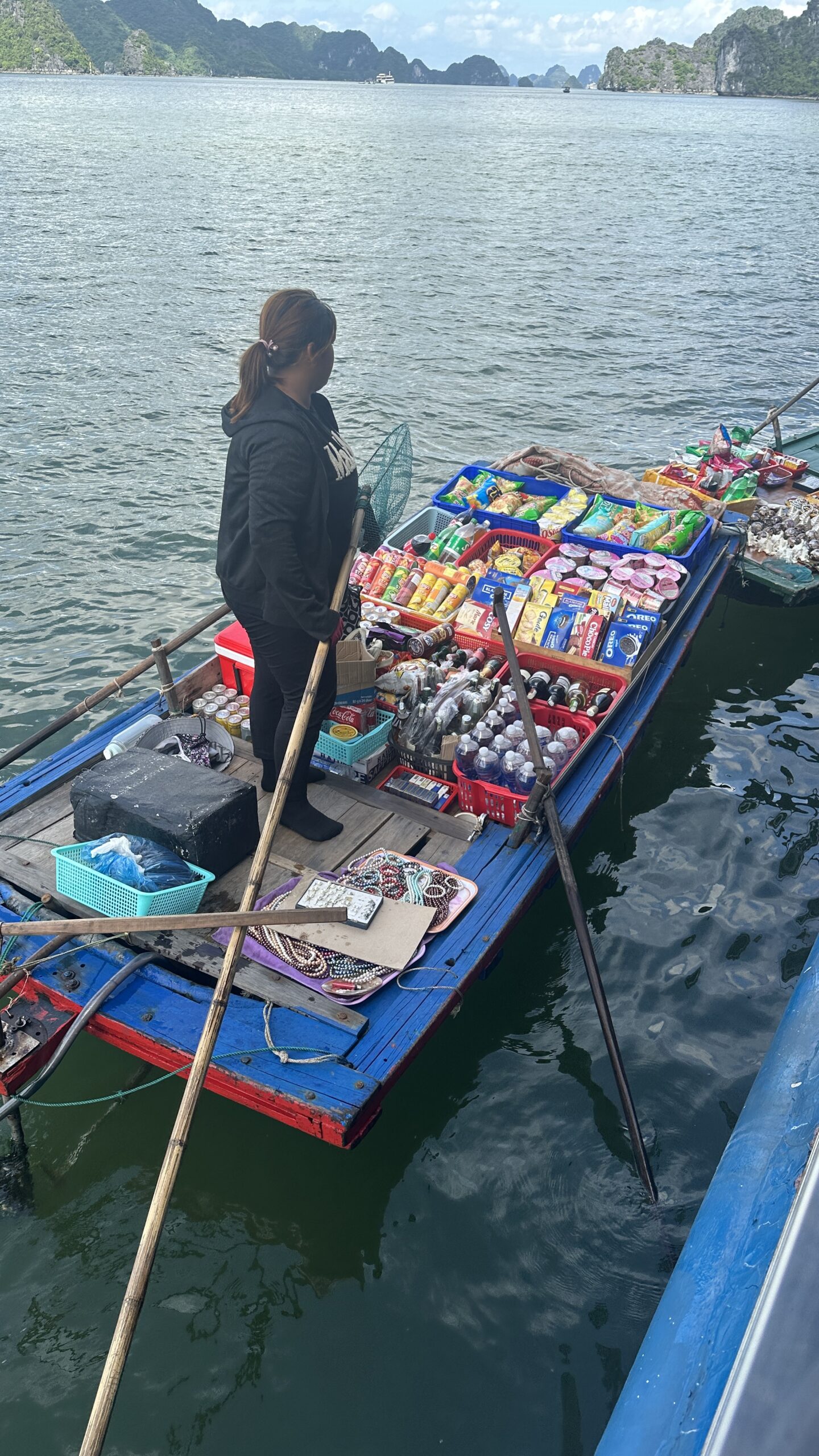 Image of a Convenience store on a boat, offering a variety of goods to tourists in Ha Long Bay.