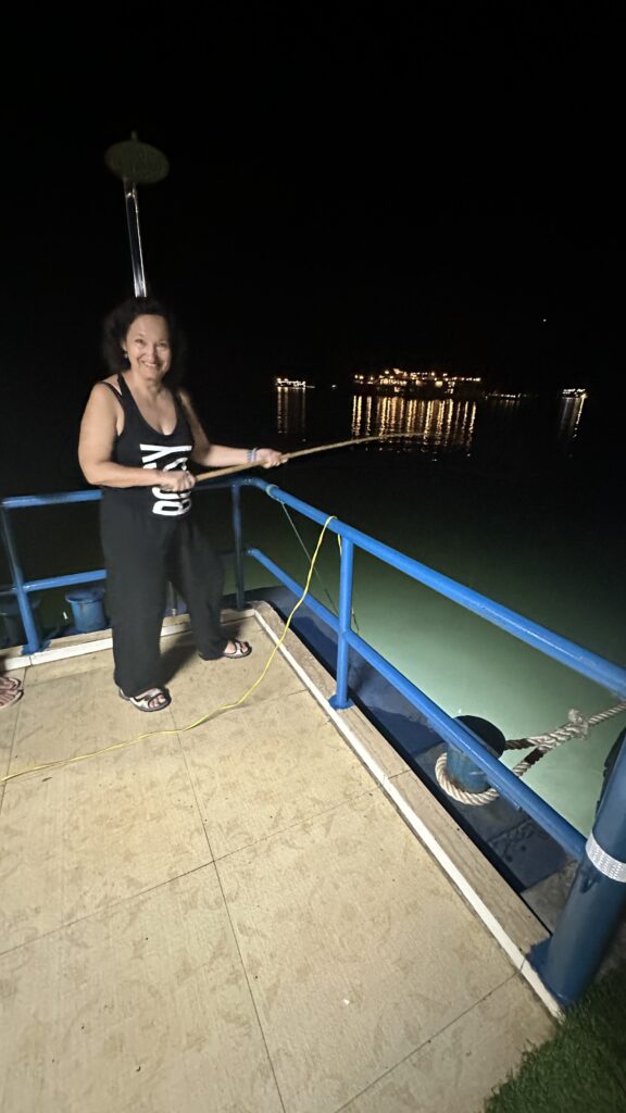 image of the author, Fauzia Rizvi's friend, Inga fishing from the cruise at 